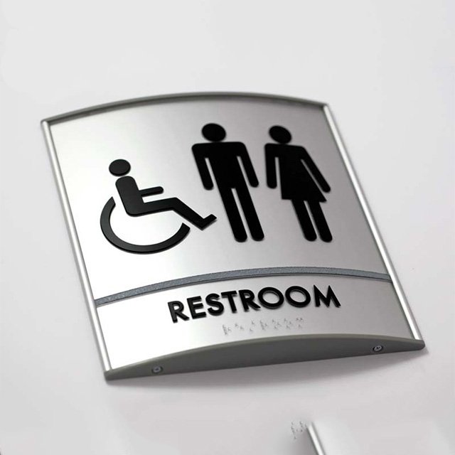 curved restroom braille signs
